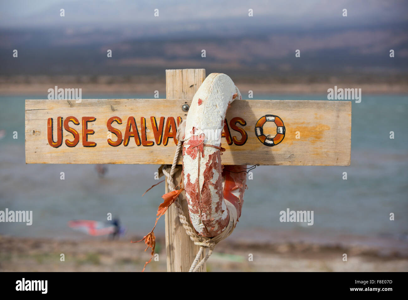 Life buoy and sign dangerous to swim, Lake of Wind, Argentina Stock Photo