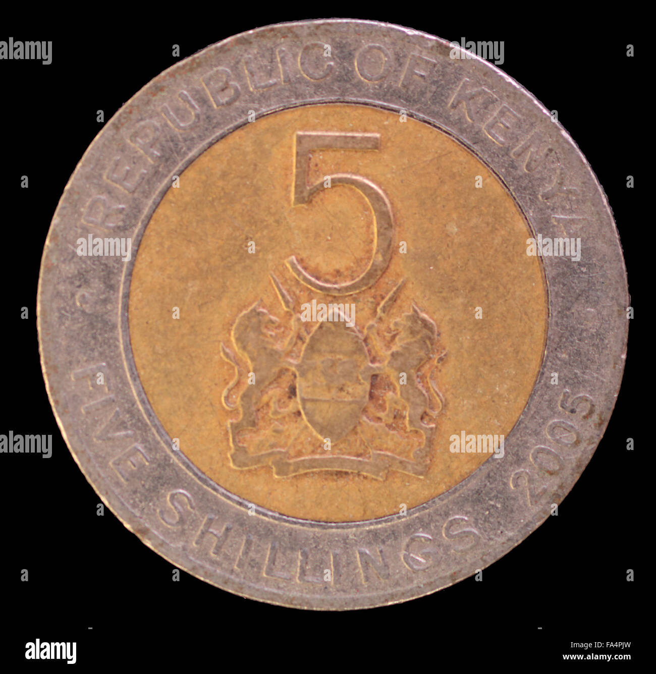 The tail face of 5 shillings coin, issued by Kenya in 2005, depicting the lions and the shield, symbol of the country. Image iso Stock Photo