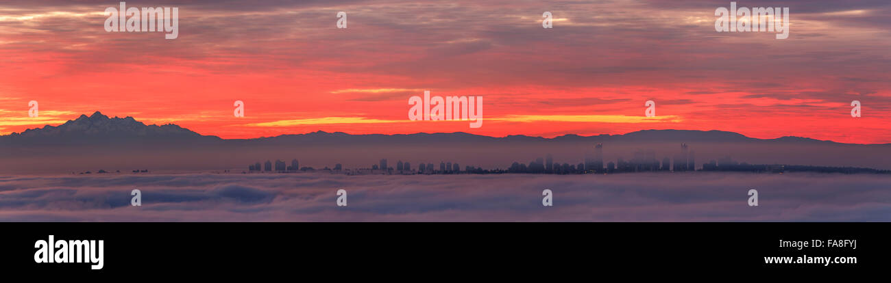 morning glow and city Burnaby BC, intense golden cloudscape. Stock Photo