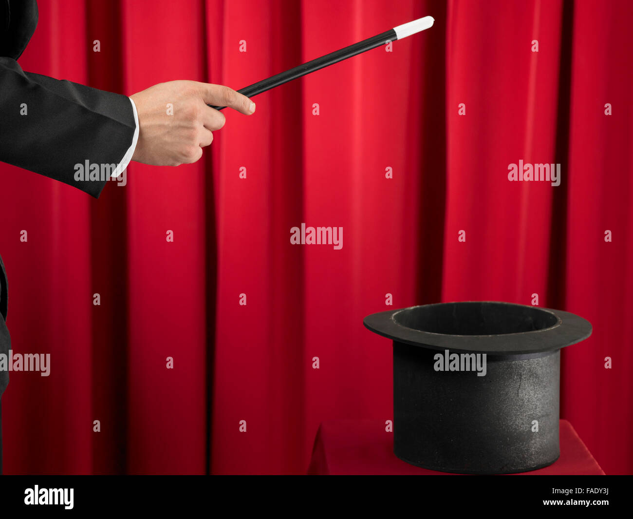 Magician Holding Magic Wand and Top Hat Stock Photo