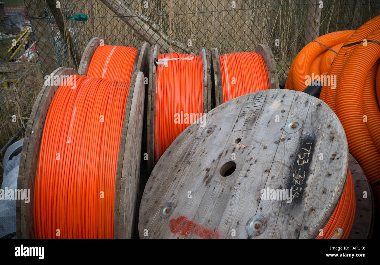 HENGELO, NETHERLANDS - MARCH 28, 2015: Drums with orange fiber cable owned by Reggefiber, a Dutch company that specializes in th Stock Photo