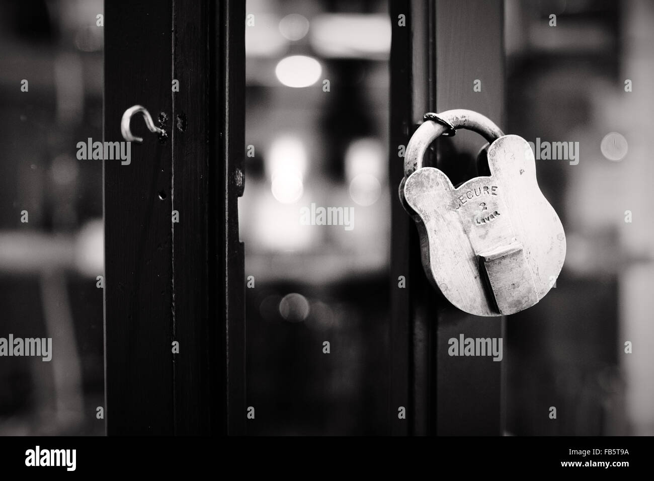 2 lever padlock with the word secure on on a wooden frame in a glass cabinet. Stock Photo