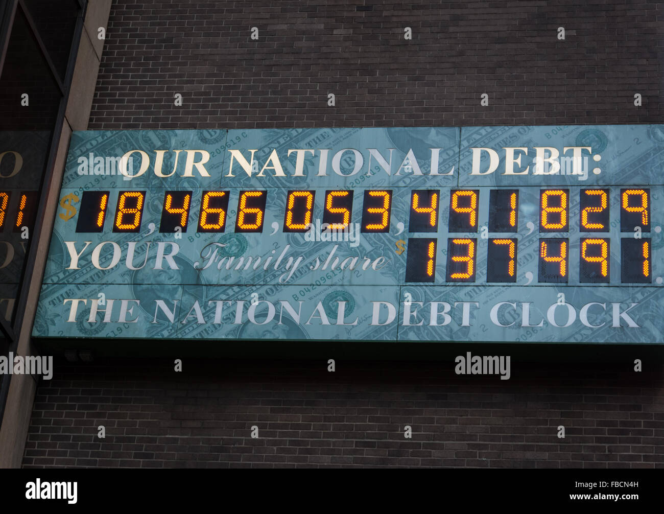 The National Debt Clock shows the state of the country and world economy, located in New York City Stock Photo