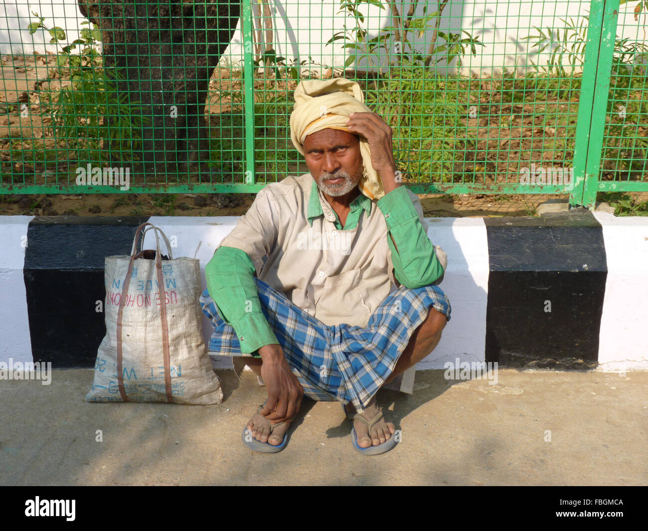 A Poor Indian Man Sitting on the Street Stock Photo