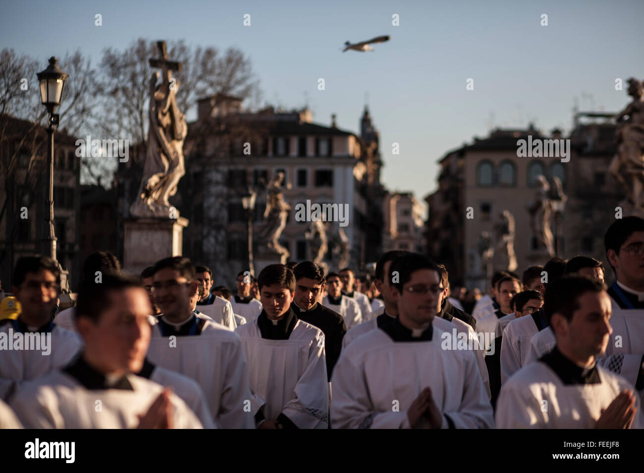 Rome, Italy. 05th Feb, 2016. Seminarians cross Ponte Sant'Angelo during a procession to honor the exhumed body of mystic saint Padre Pio. The body of one of the most popular Roman Catholic saints, Padre Pio began an overland journey in a crystal coffin to be display today in St. Peter's Basilica at the Vatican. Credit:  Christian Minelli/Pacific Press/Alamy Live News Stock Photo