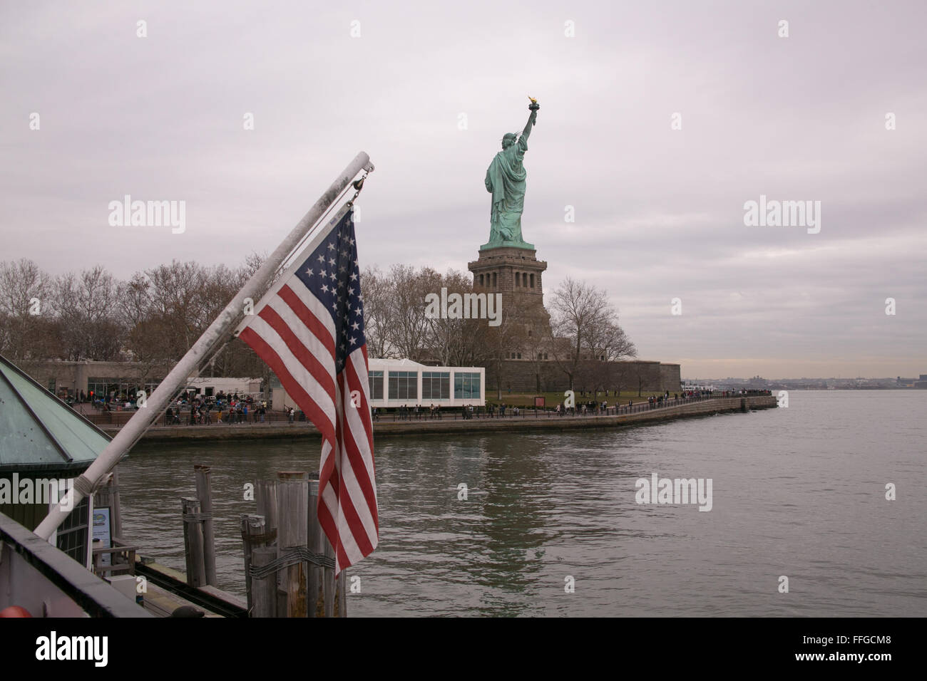 American flag and the Statue of Liberty in New York. Stock Photo