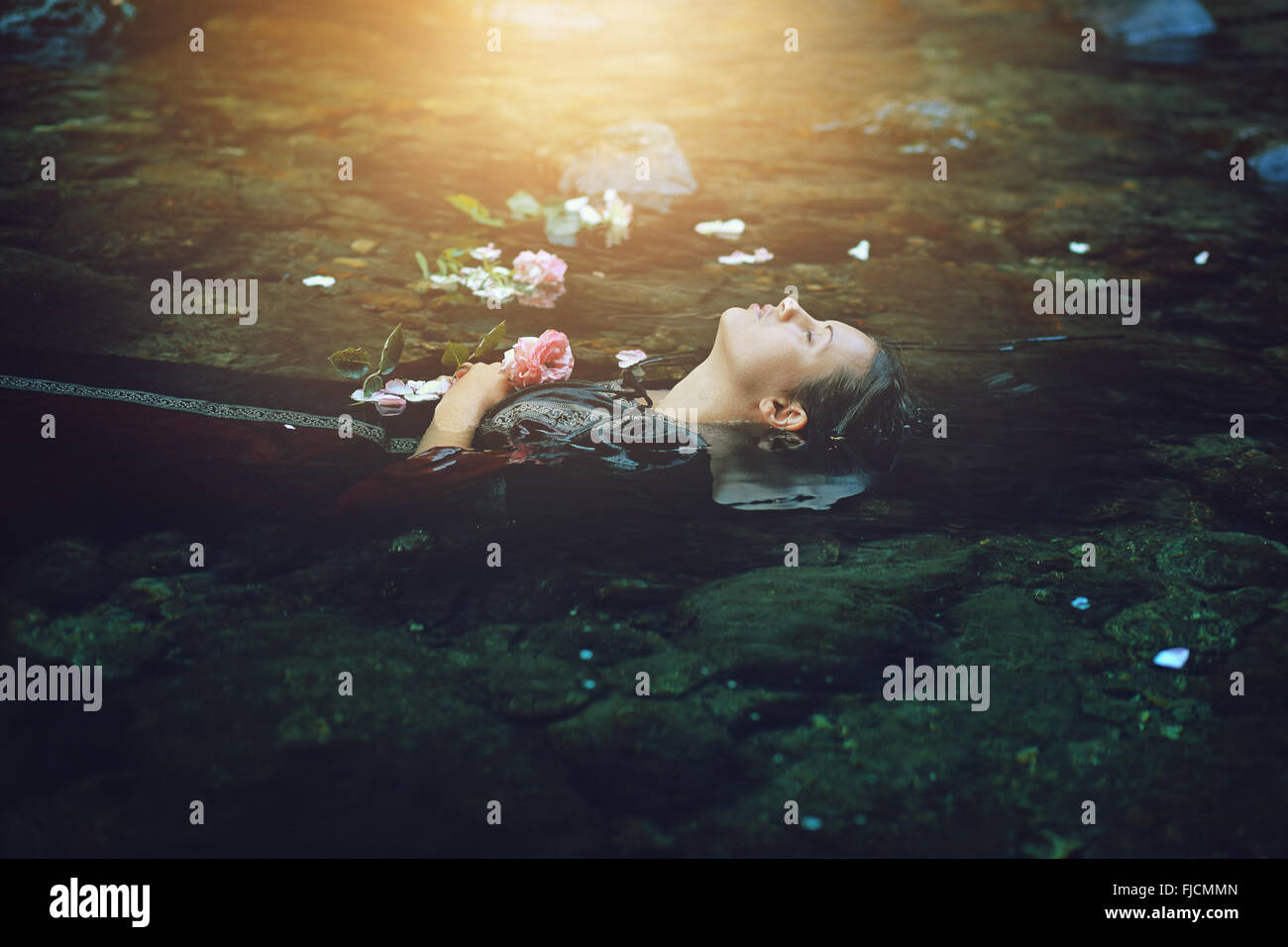 Floating dead woman in dark river . Ophelia conceptual Stock Photo