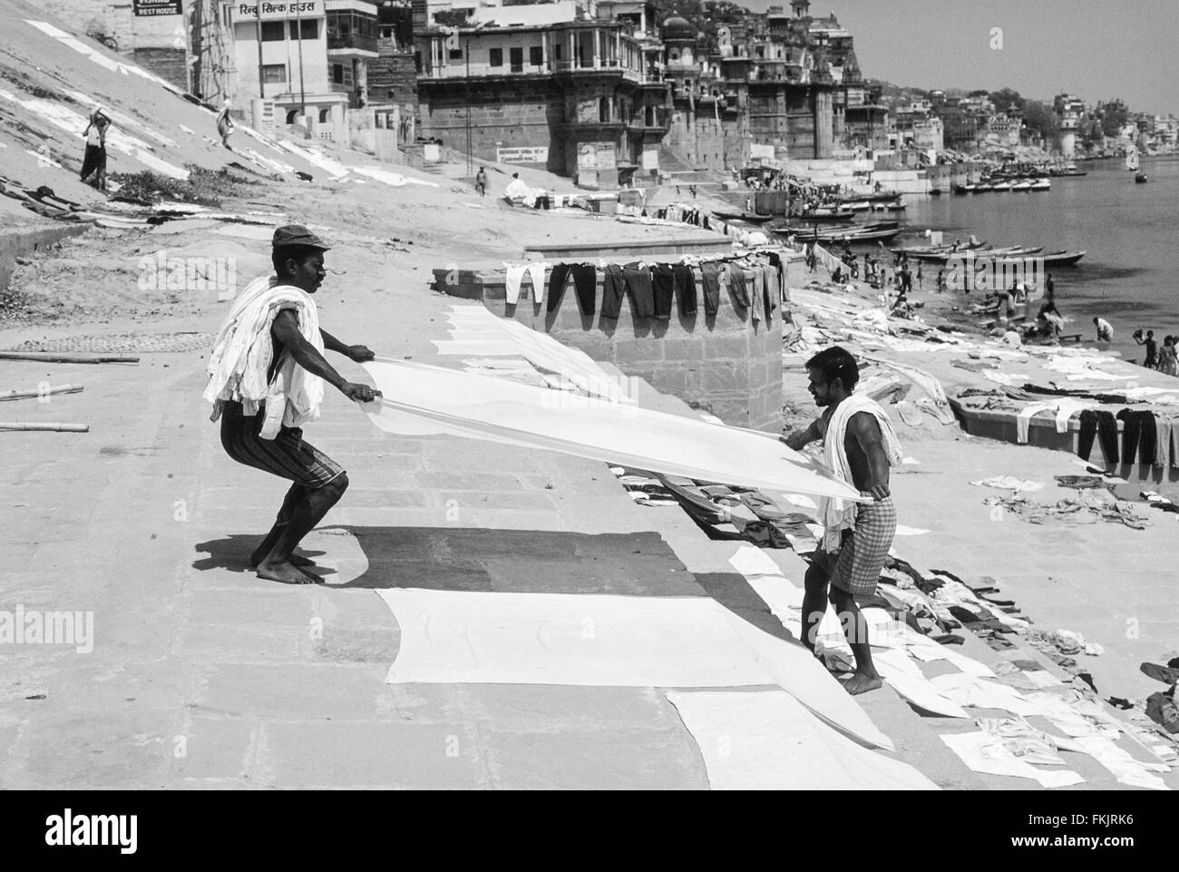 Wash day.Putting out, wash,washing,laundry to dry on ghats on banks of sacred Ganges River after washing in polluted waters,Varanasi. Stock Photo