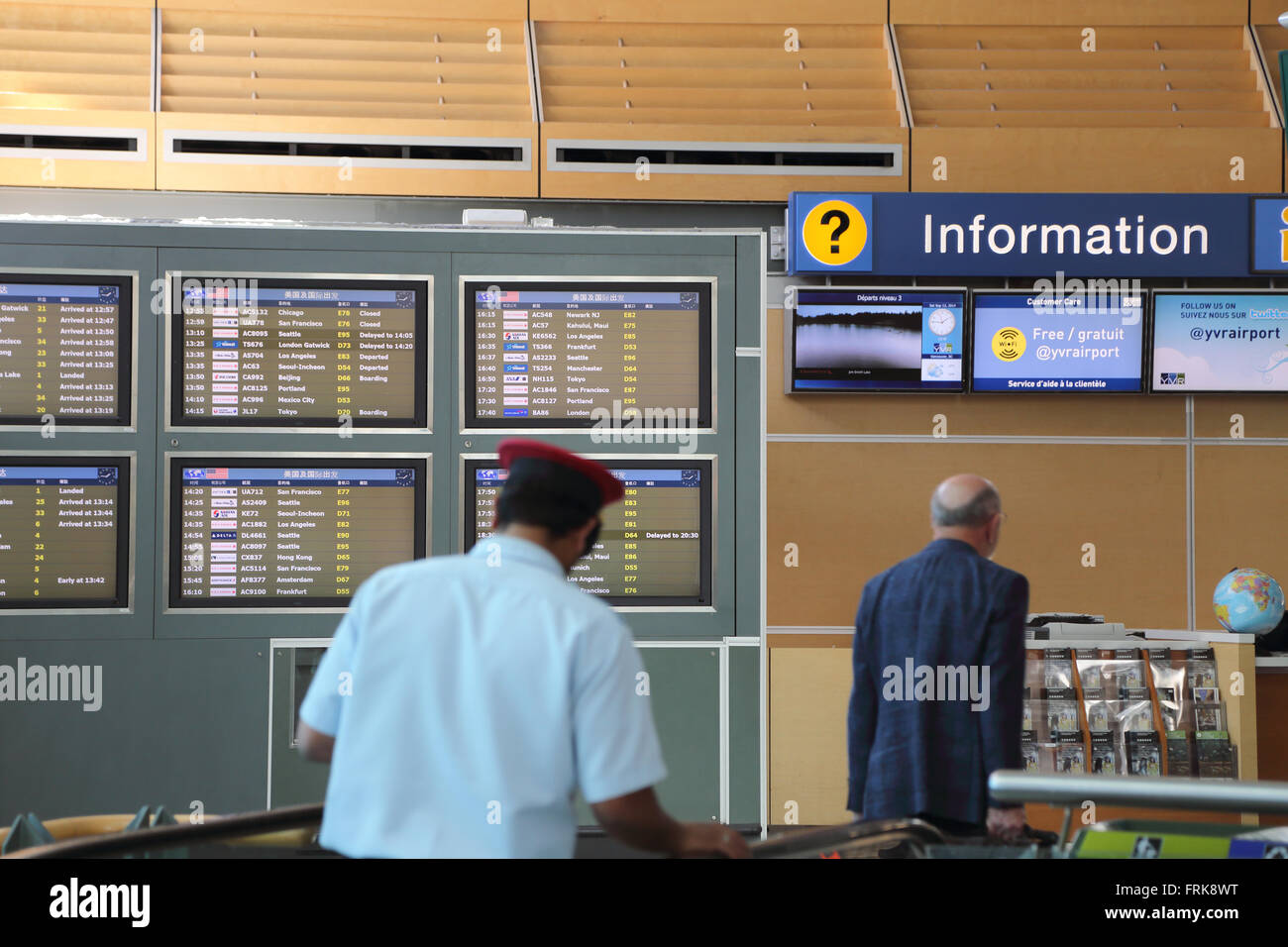 Vancouver, BC Canada - September 13, 2014 : People asking some information insdie the YVR airport in Vancouver BC Canada. Stock Photo