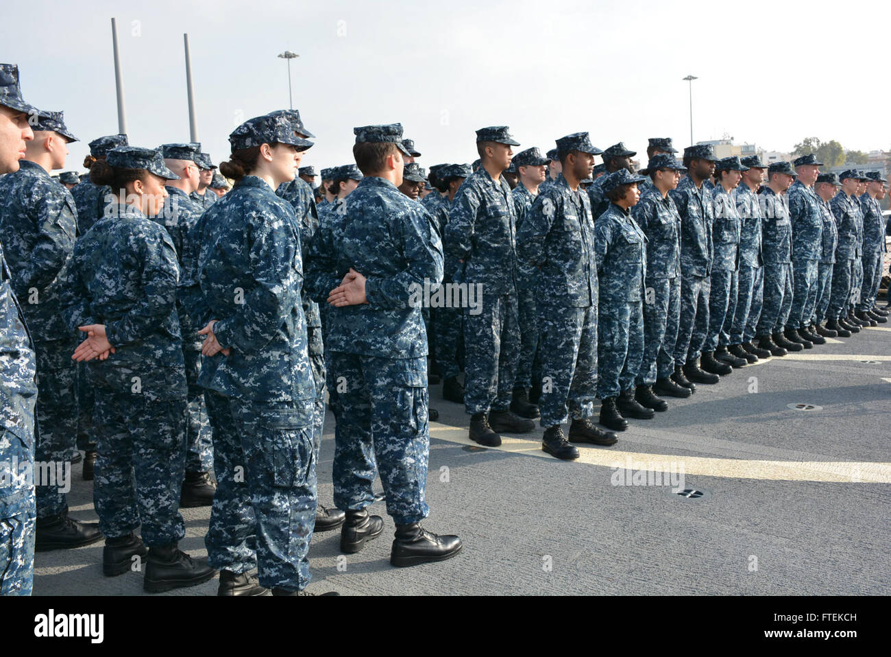 150121-N-ZZ999-012 PIRAEUS, Greece (Jan. 21, 2015) USS Cole (DDG 67) Sailors stand at parade rest during a change of command ceremony, while moored in Piraeus, Greece, Jan. 21, 2015. Cole, an Arleigh Burke-class guided-missile destroyer, homeported in Norfolk, is conducting naval operations in the U.S. 6th Fleet area of operations in support of U.S. national security interests in Europe. (U.S. Navy photo by Boatswain’s Mate Seaman Taylor/Released) Stock Photo