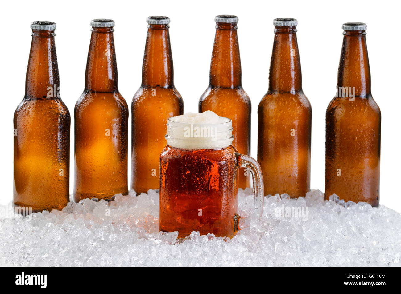 Glass of beer with six pack of ice cold bottles isolated on white background Stock Photo