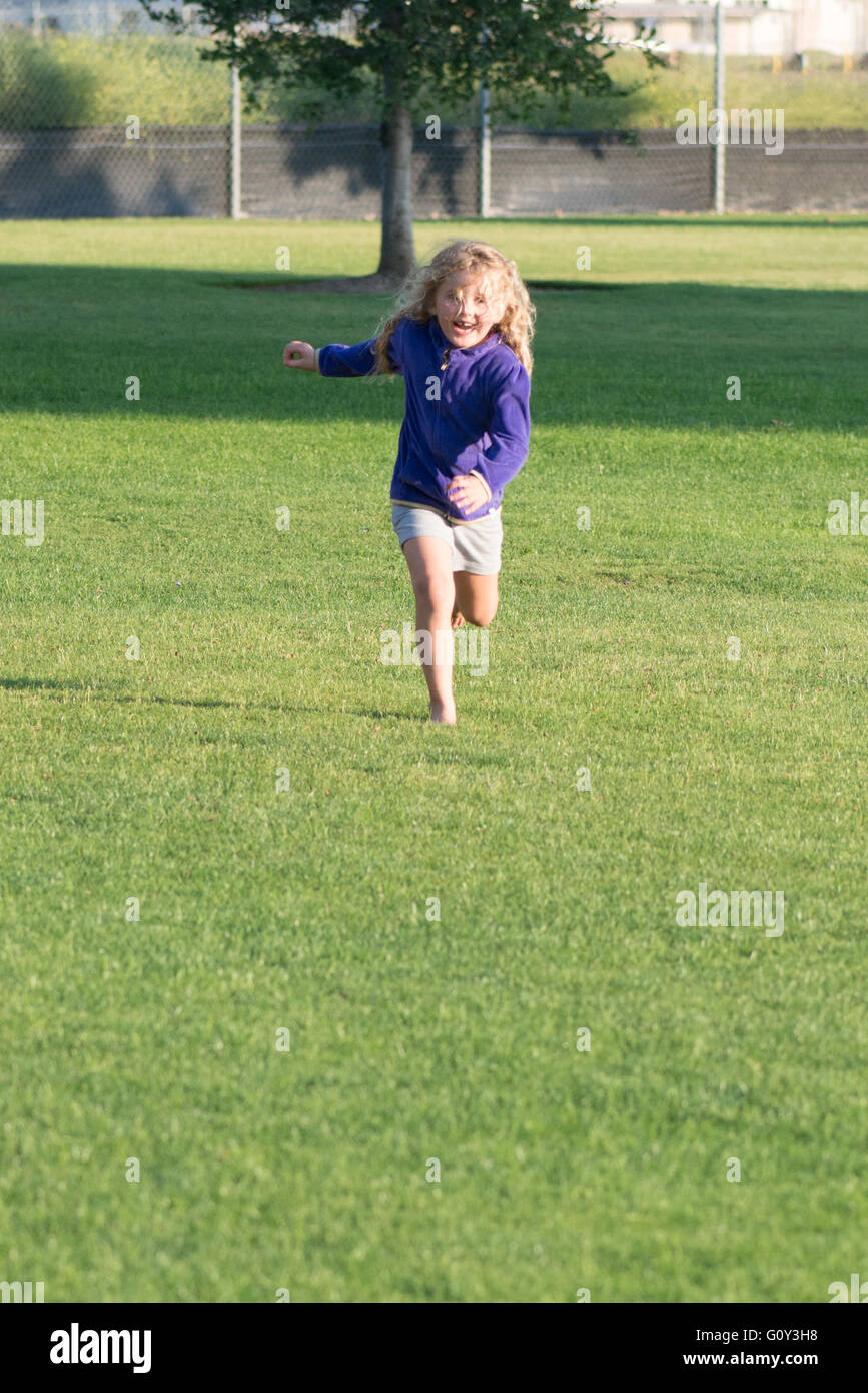 Girl running in park Stock Photo