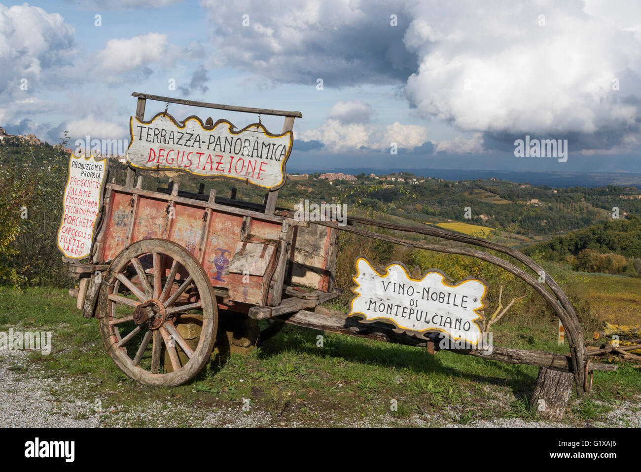 traditional cart for wine transport in front of Montepulciano skyline Stock Photo