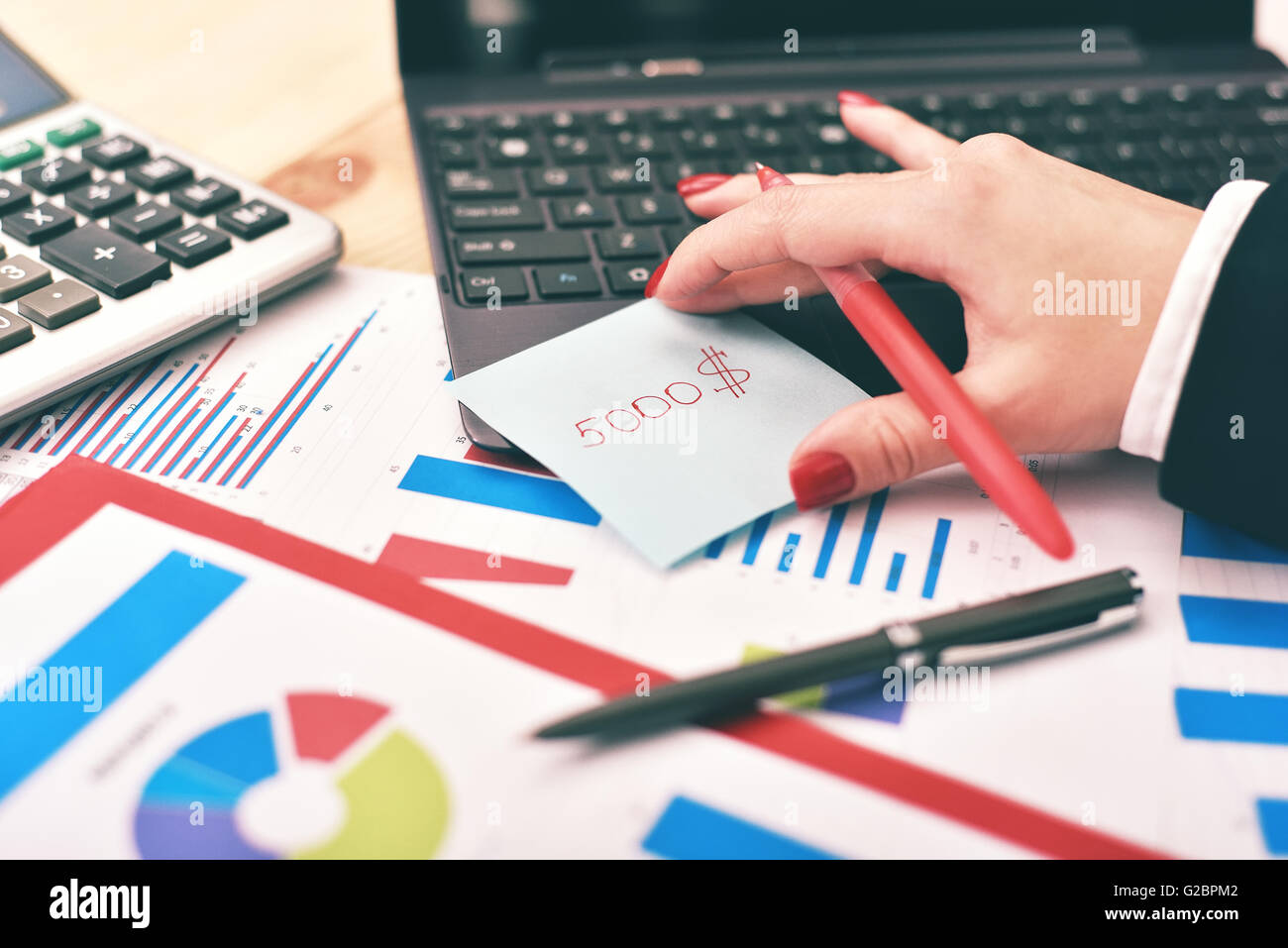 trader woman holding a sticker with the dollar amount Stock Photo