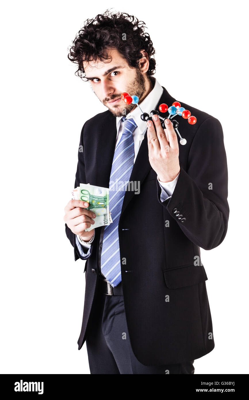 a businessman wearing a suit and a tie holding a trinitrotoluene tnt molecular model and money bills isolated over white Stock Photo