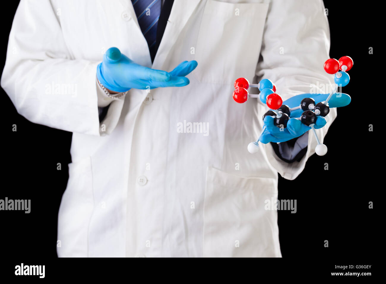 a doctor or researcher with a white lab coat holding a trinitrotoluene tnt molecular model Stock Photo