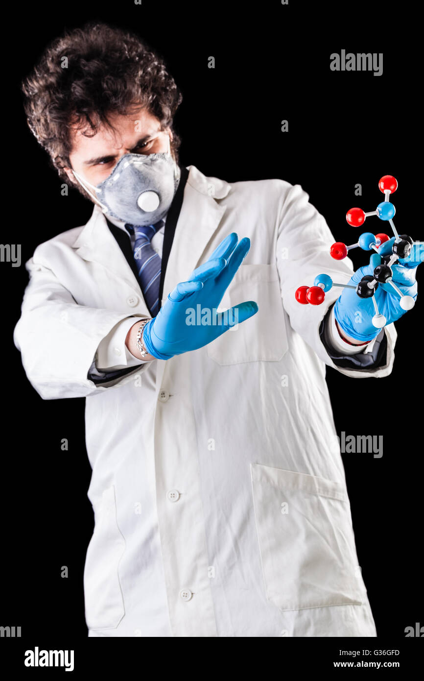 a doctor or researcher with a white lab coat holding a trinitrotoluene tnt molecular model Stock Photo