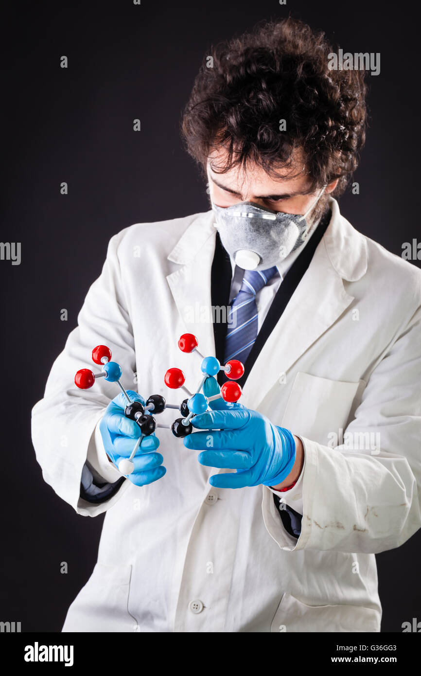 a doctor or researcher with a white lab coat holding a trinitrotoluene tnt molecular model Stock Photo