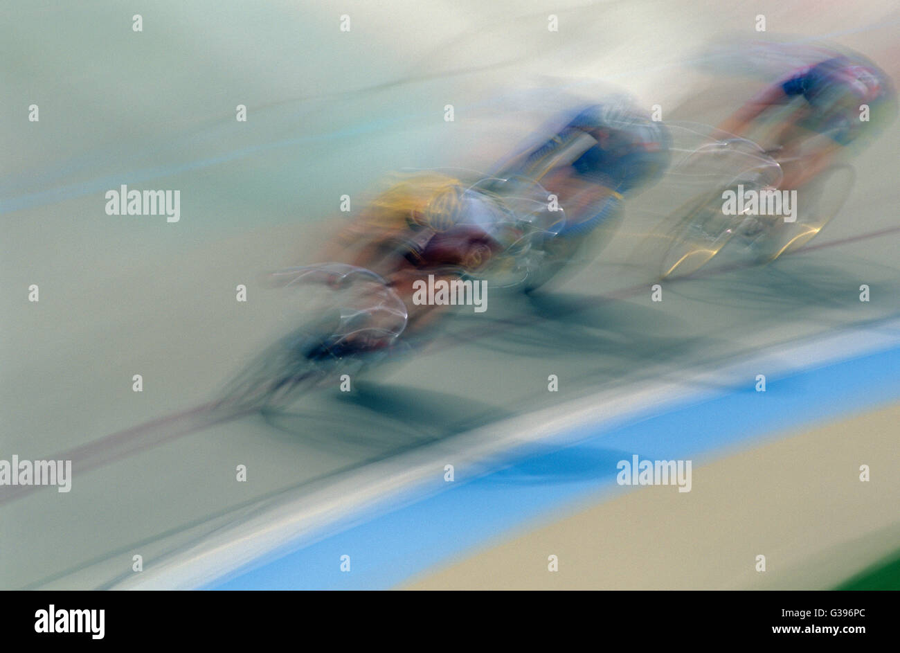 Blurred Motion of Three Cyclists Racing on a Race Track Stock Photo