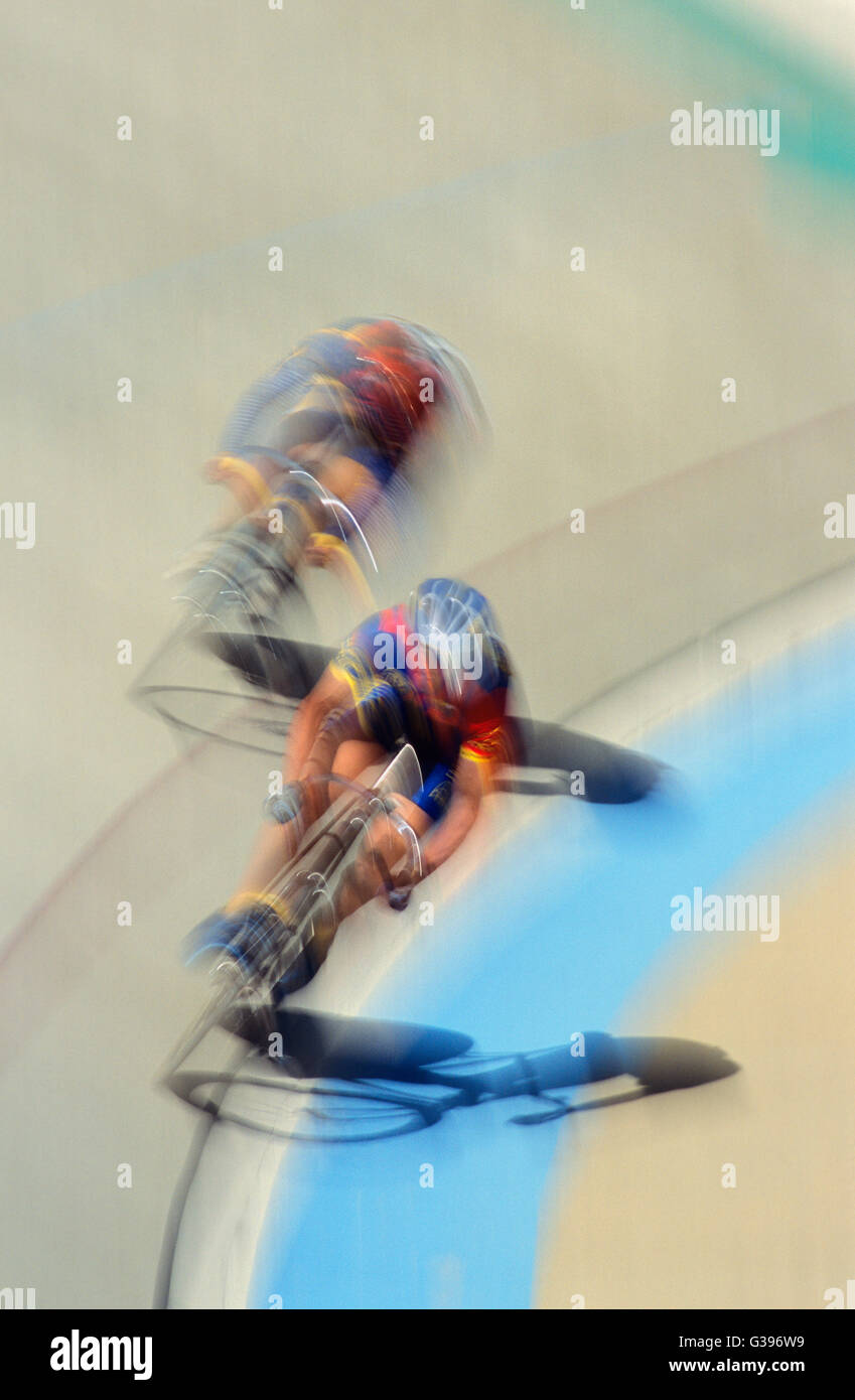 Blurred Motion of Two Cyclists Racing on a Race Track Stock Photo