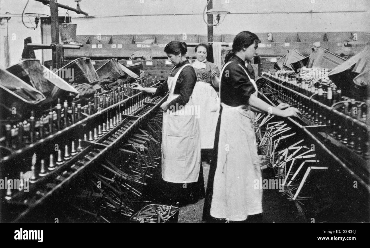 Bobbin winding in a Lancashire  cotton mill.        Date: circa 1900 Stock Photo