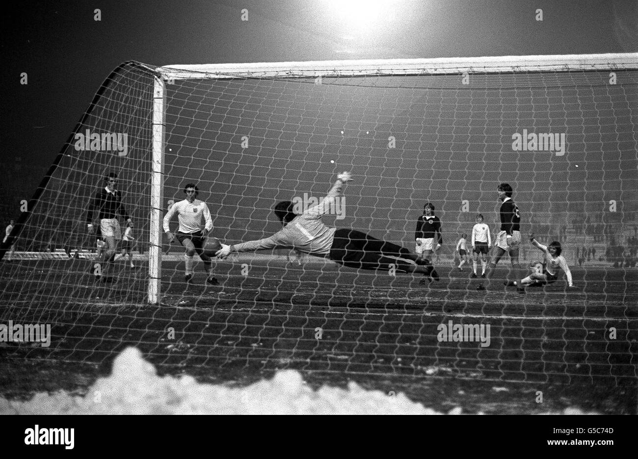 Allan Clarke (left) angles a shot under the Scotland goalkeeper's body to score his second, and England's fifth goal five minutes from the end of the Centenary International at Hampden Park. England won 5-0 Stock Photo