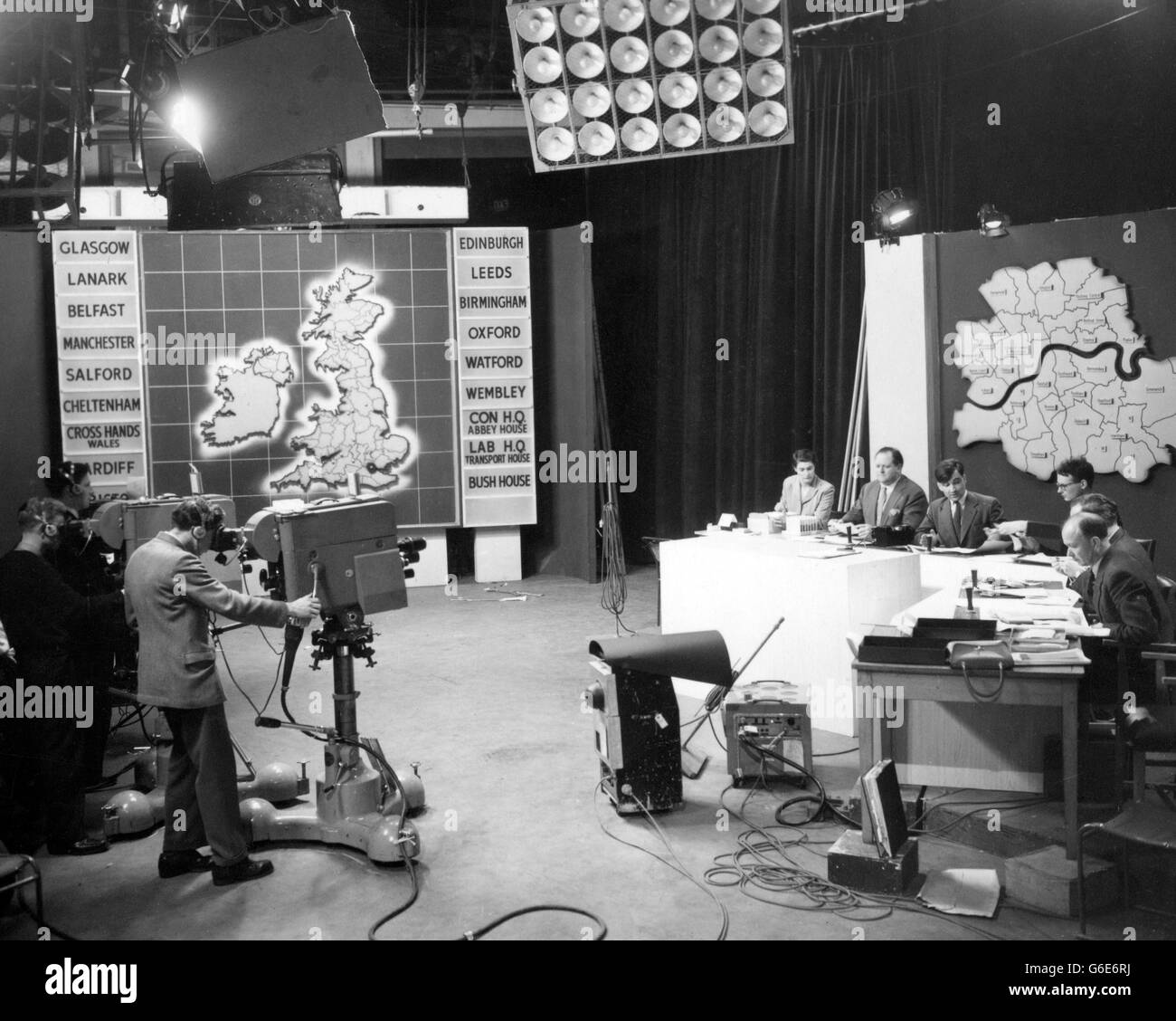 Richard Dimbleby (second from left), and members of his team, rehearse in front of the TV cameras at Lime Grove Studios, London, for the presentation of the General Election results. Stock Photo