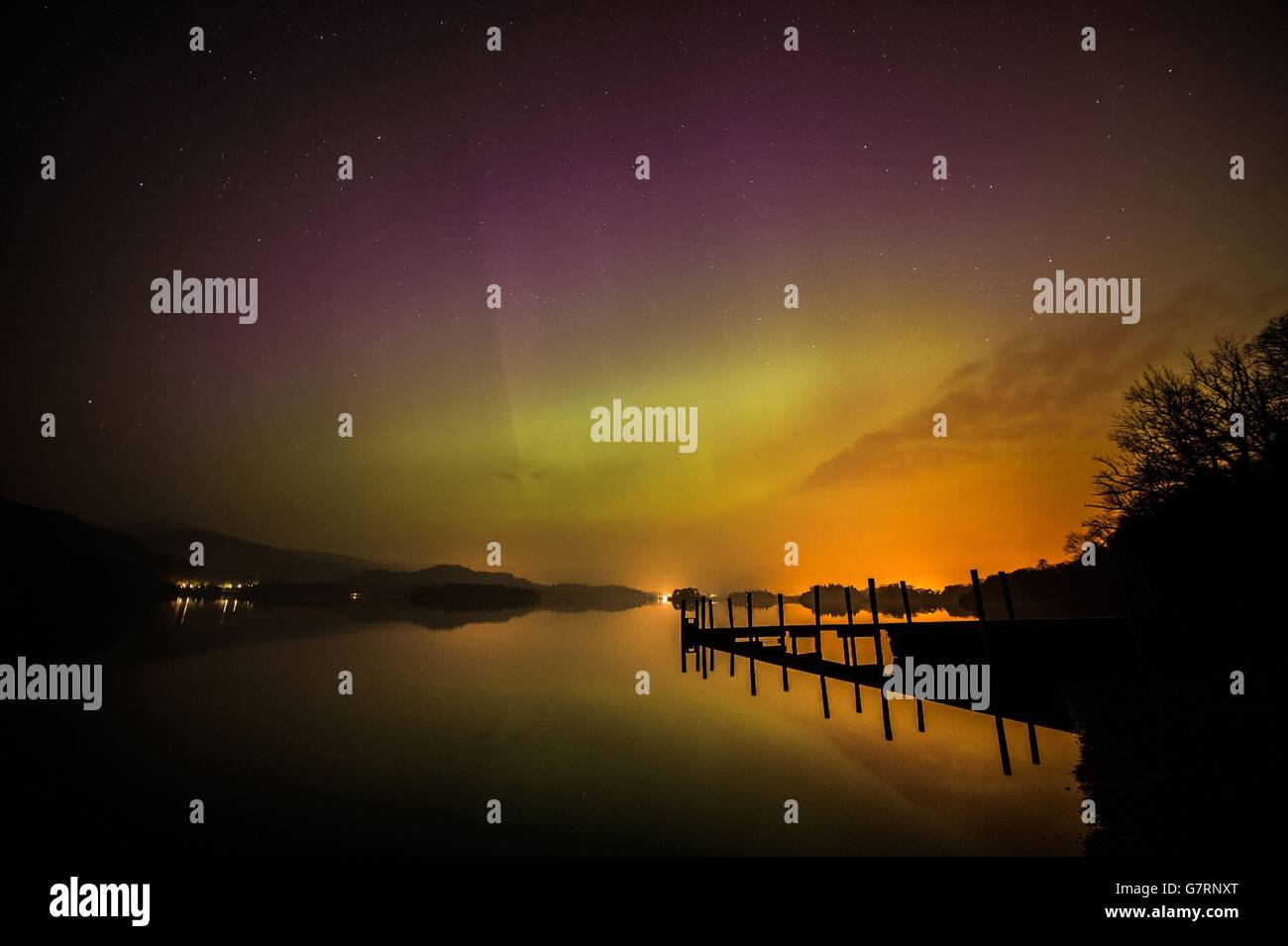 The aurora borealis, or the northern lights as they are commonly known, over Derwent water near Keswick in the Lake District. Stock Photo