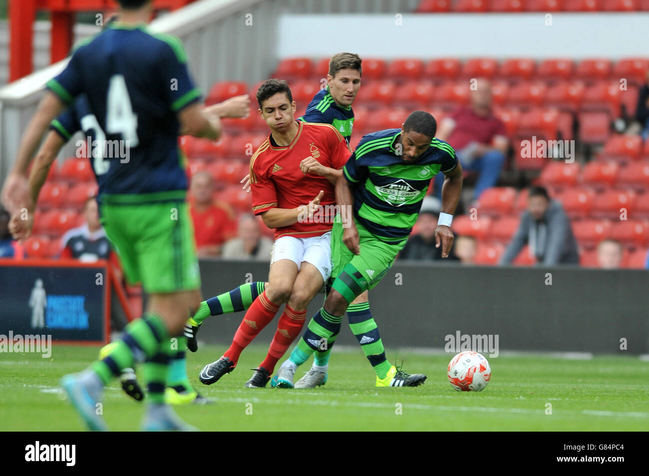 Soccer - Pre Season Friendly - Nottingham Forest v Swansea City - City Ground. Nottingham Forest's Tyler Walker is tackled by Swansea City's Ashley Williams Stock Photo