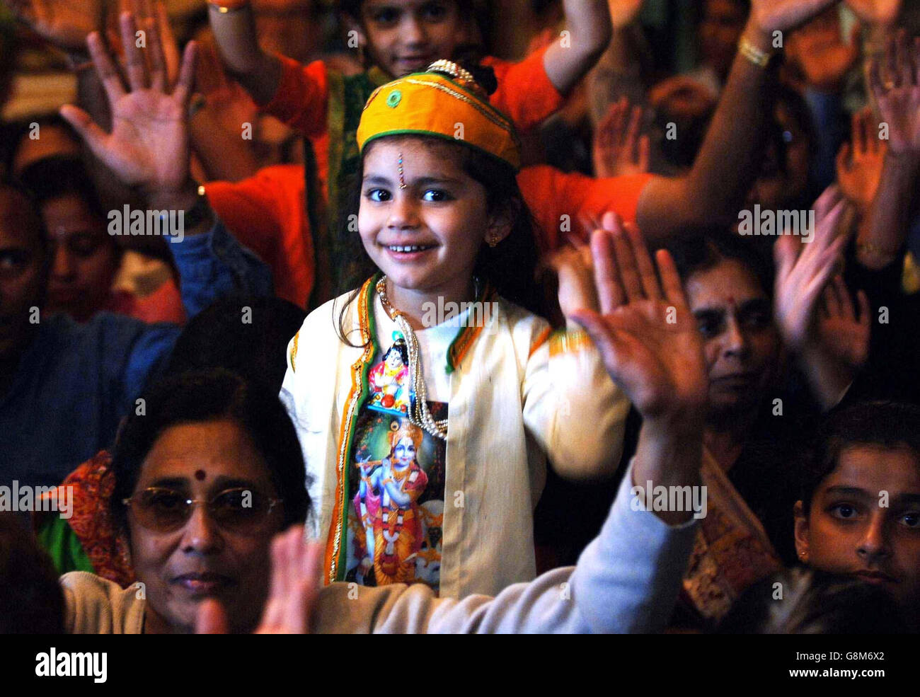 Three-year-old Komal Madh attends Janmashtami, a festival celebrating the birthday of the Hindu deity Lord Krishna in Aldenham, Watford Friday August 26, 2005. It is the largest gathering of Hindus outside India with 75,000 people expected to take part. The celebration marks the 5,000-year-old festival of Janmashtami, the birthday of Lord Krishna who is the reincarnation of Lord Vishnu. See PA story RELIGION Hindu. PRESS ASSOCIATION Photo. Photo credit should read: Fiona Hanson/PA. Stock Photo