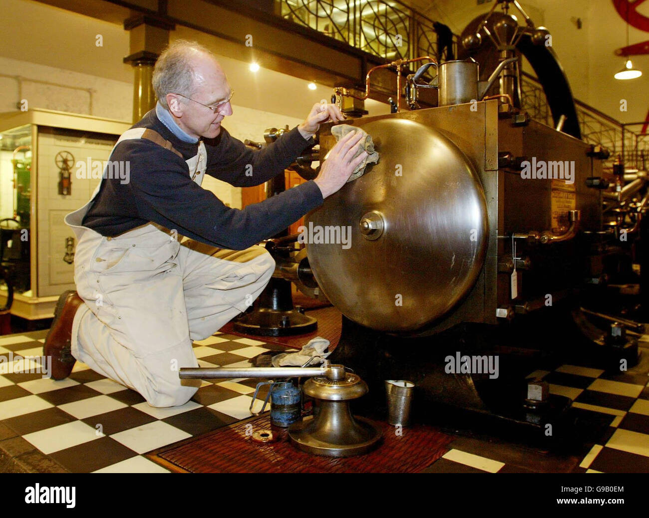 Painter Alan Roberts polishes an 1889 Corliss Horizontal Steam Engine at the British Engineerium in Hove, East Sussex, where an unrivalled collection of steam engines and engineering artefacts dating back to the industrial revolution went on show today ahead of auction later this week. Stock Photo