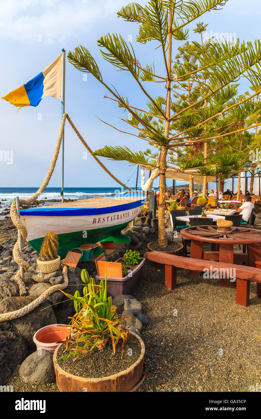 EL GOLFO, LANZAROTE ISLAND - JAN 12, 2015: fishing boat in typical restaurant on coast of Lanzarote island in El Golfo fishing village. Canary Islands are popular holiday destination. Stock Photo