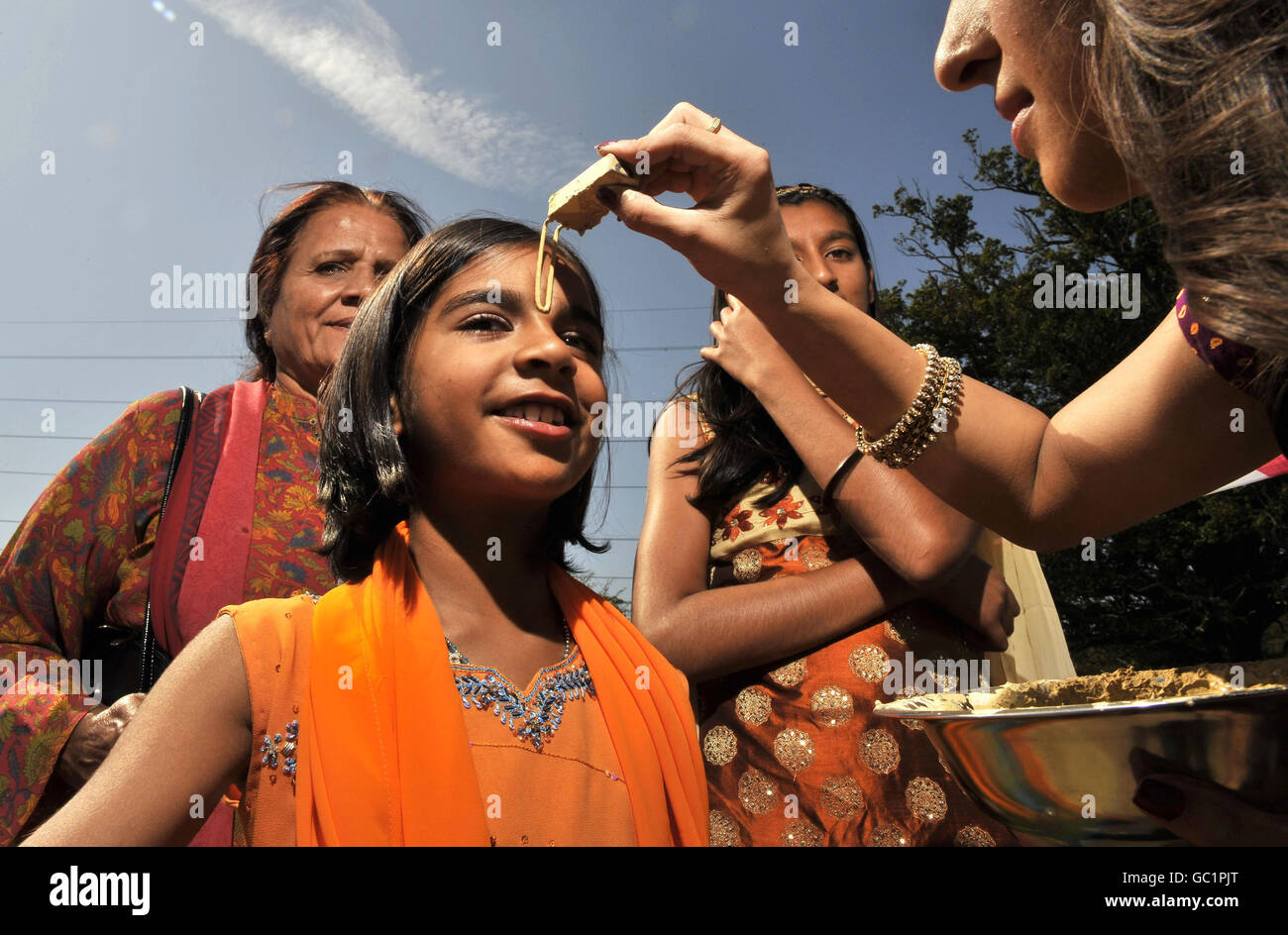 A tilak is applied to a pilgrim at the Shree Krishna Janmashtami festival at Bhaktivedanta Manor in Watford. Stock Photo