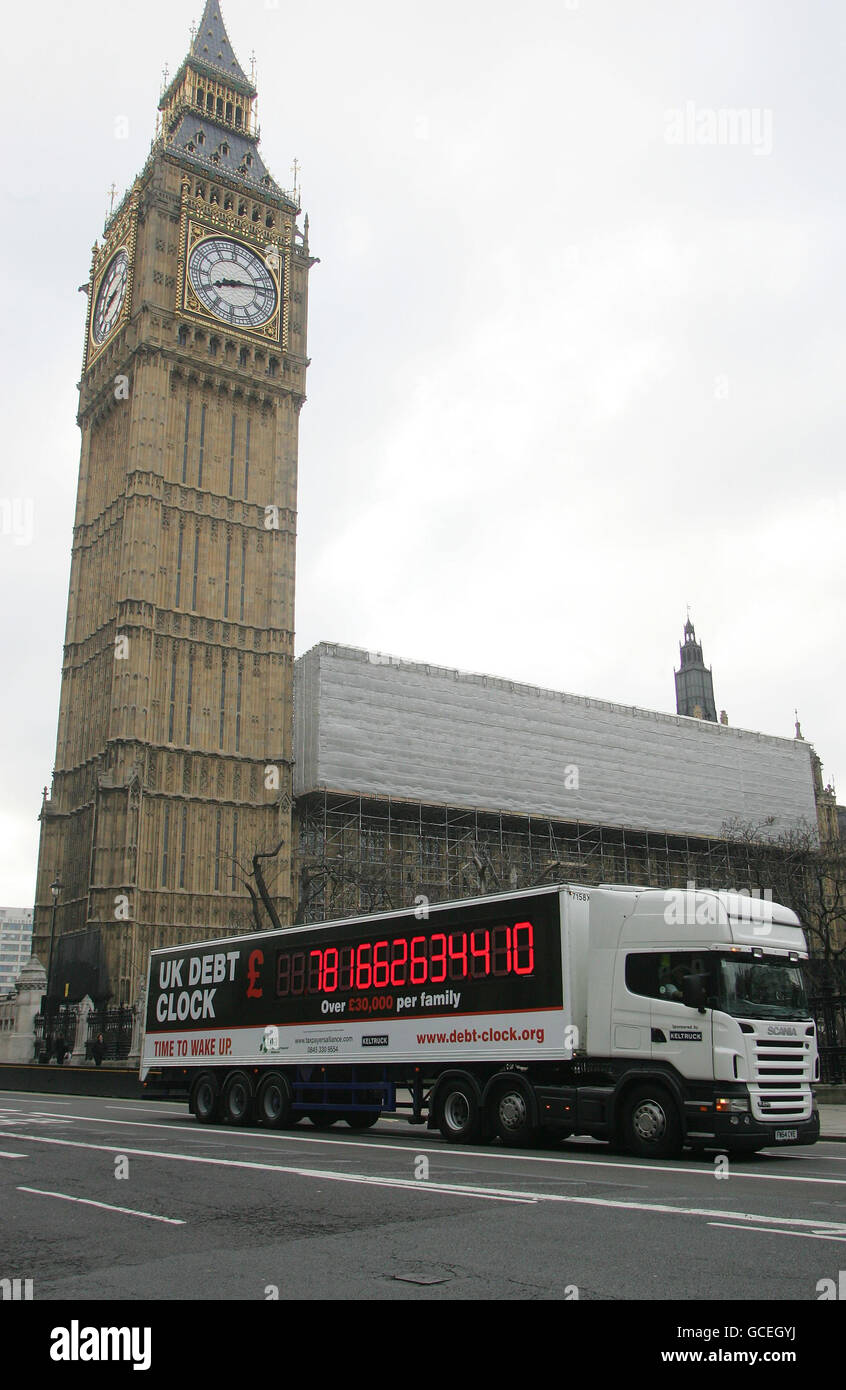 The TaxPayers' Alliance's (TPA) digital Debt Clock, which counts up the national debt, passes the Houses of Parliament in central London during the launch of a national tour. Stock Photo