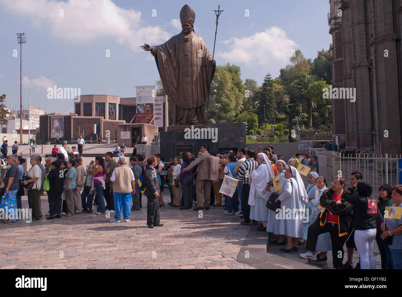 After the Mass, hundreds of people line up outside the Basilica of Guadalupe to be able to venerate Pope John Paul II's relics. Stock Photo