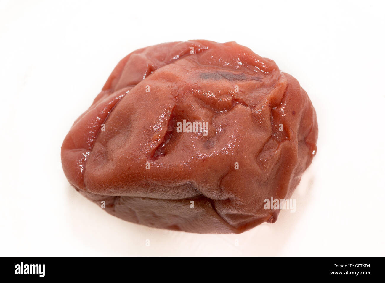 Japanese pickled apricot called Umeboshi on white isolated background Stock Photo