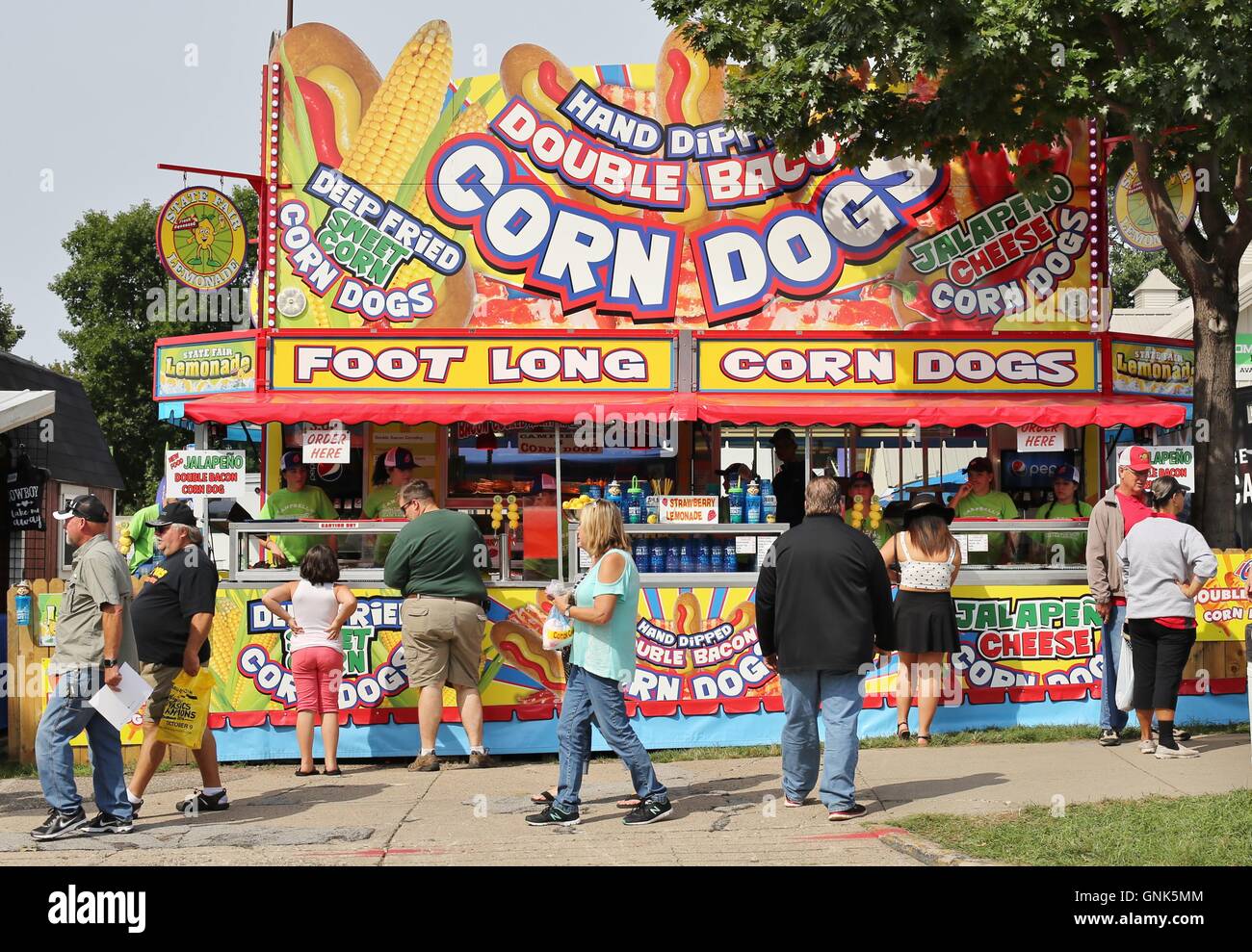 Fairgoers in front of a corn dog stand at the Minnesota State Fair. Stock Photo