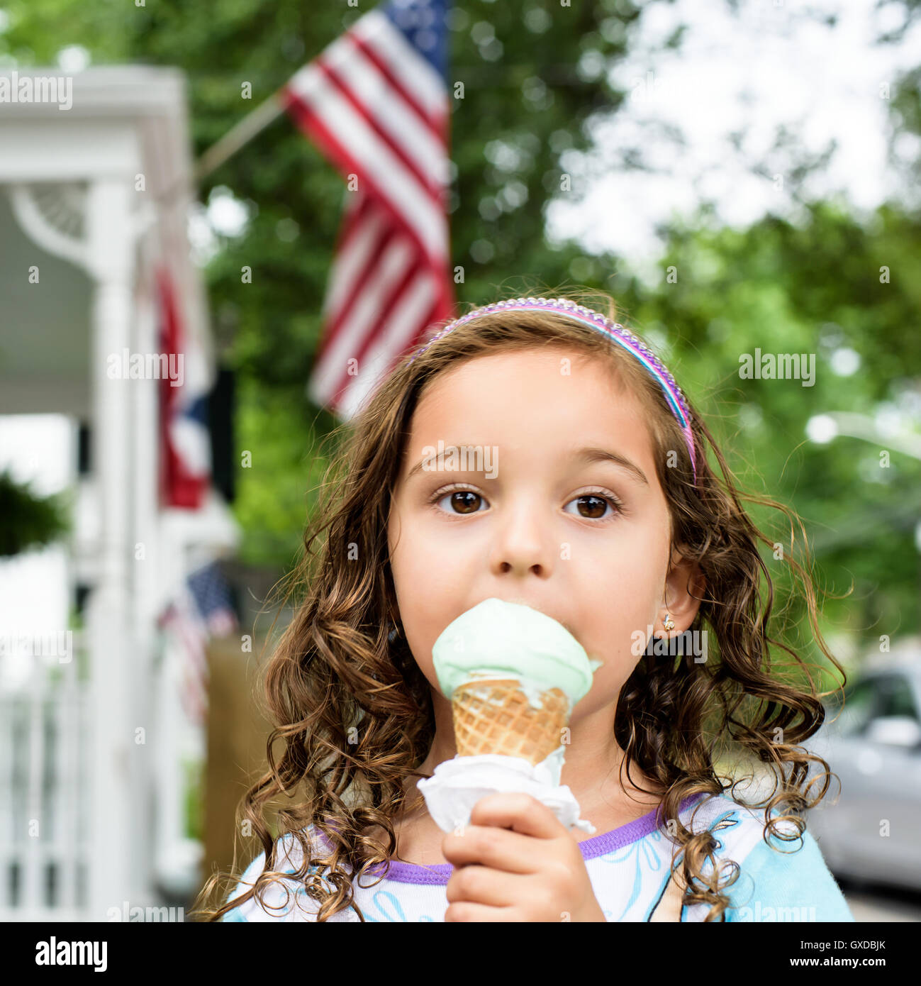 Portrait of girl eating ice cream cone on Independence Day Stock Photo