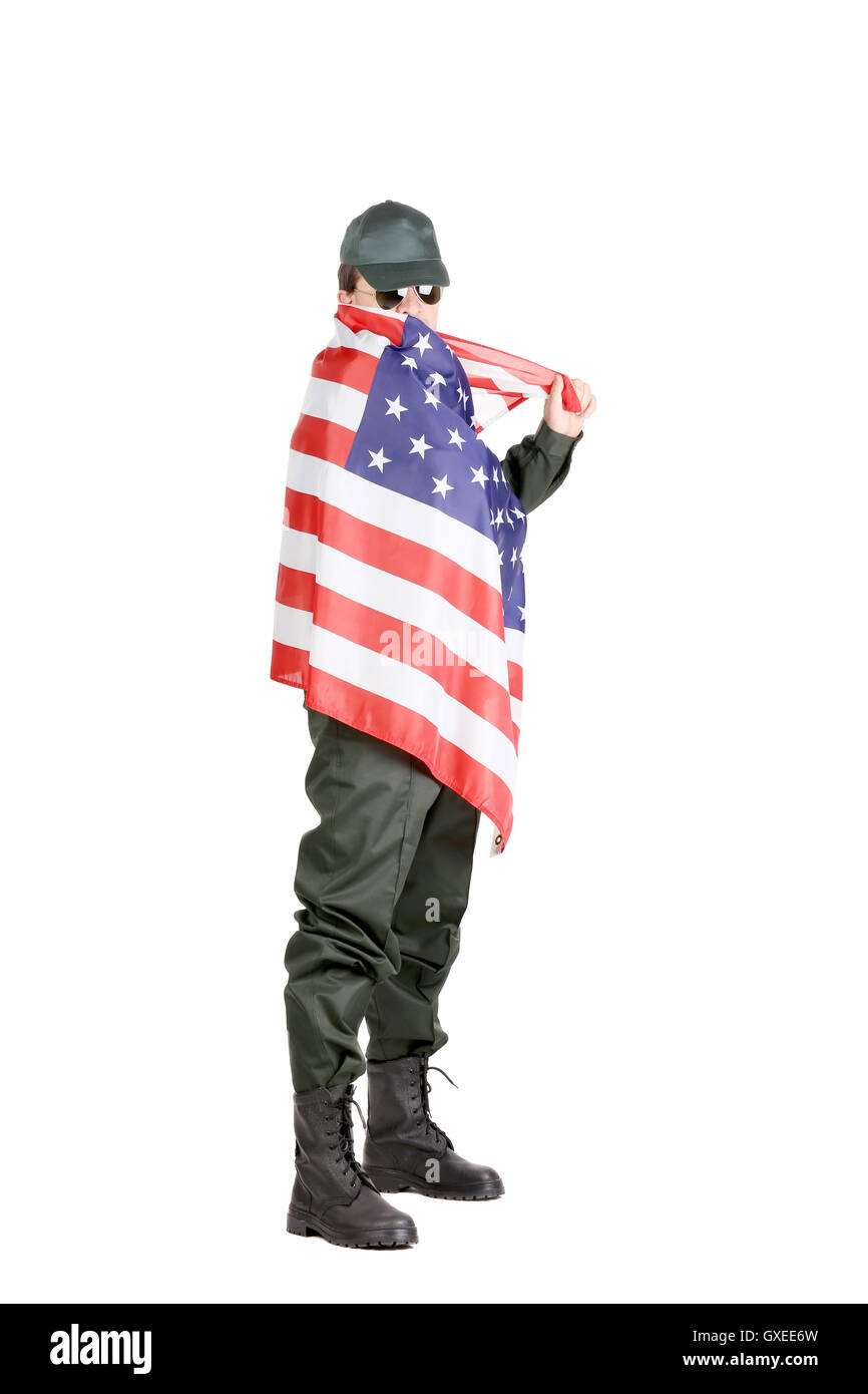 Man in workwear stands with american flag. Stock Photo