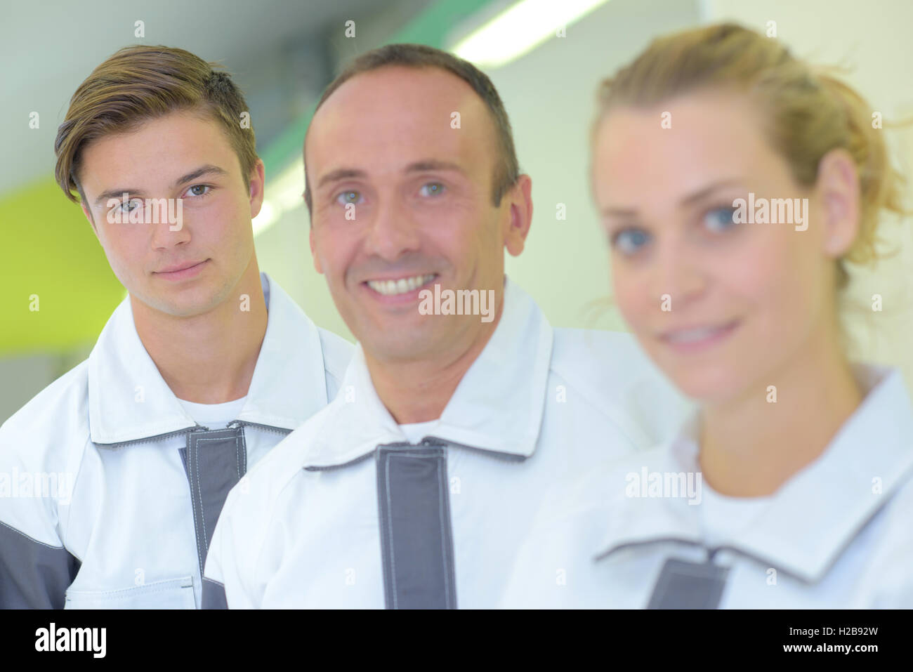 Portrait of three workers in matching coveralls Stock Photo