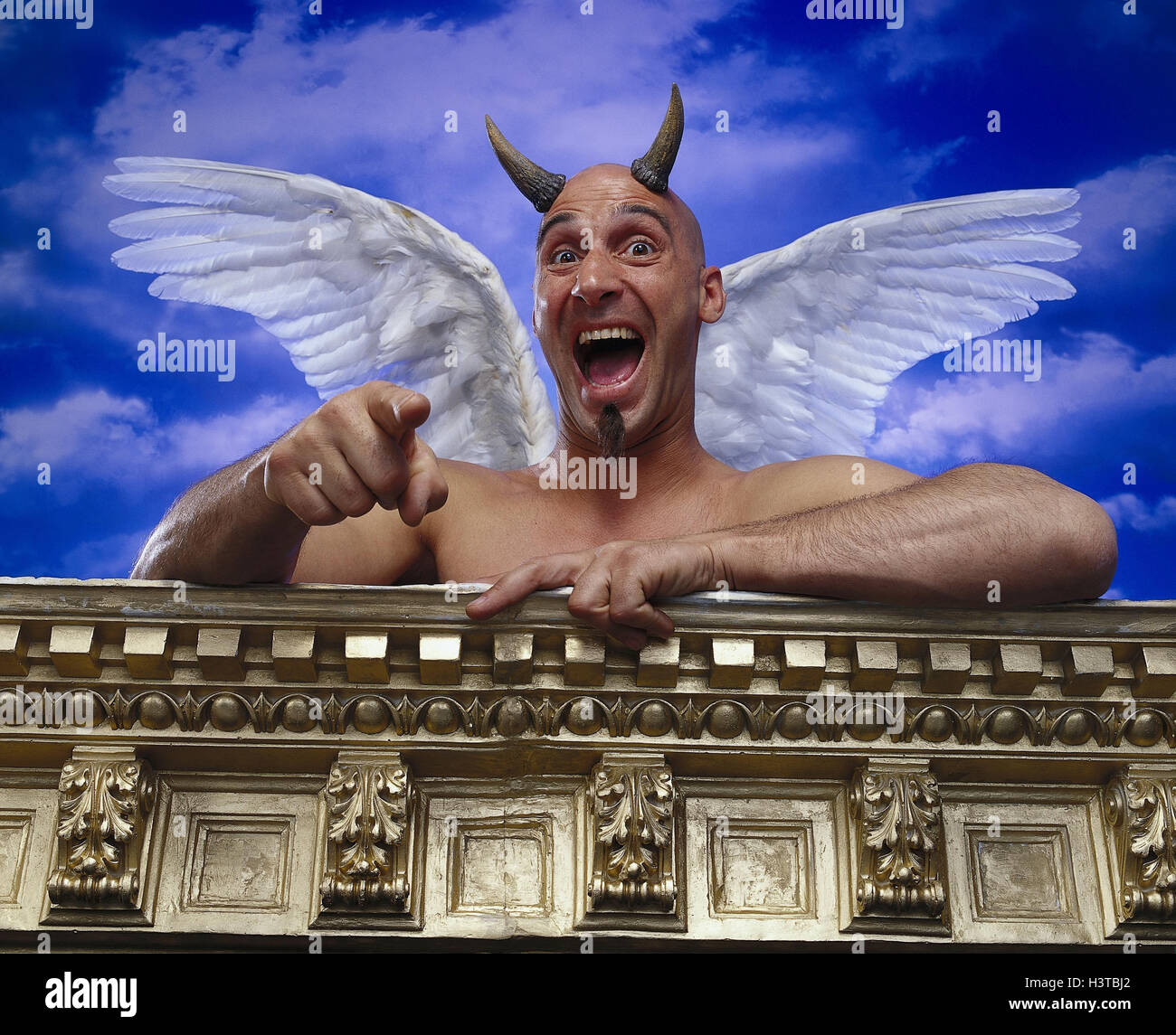 Devils, wings, gesture, ridicule, cloudy sky, poor man, free upper part of the Body, mock, travesty, mock, laughter, disdain, malicious pleasure, balustrade, outside, studio Stock Photo