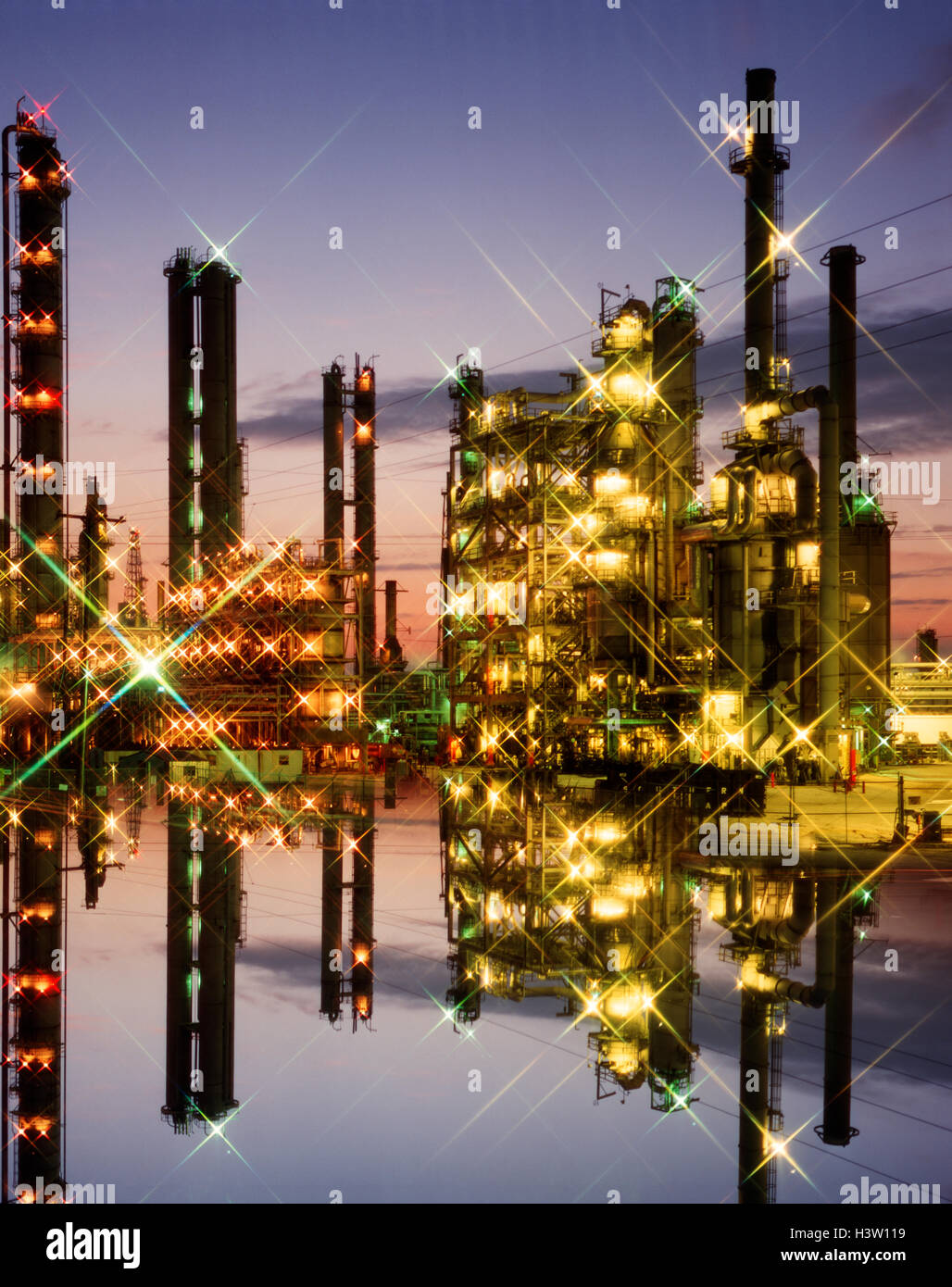 OIL REFINERY LIGHTS AT TWILIGHT Stock Photo