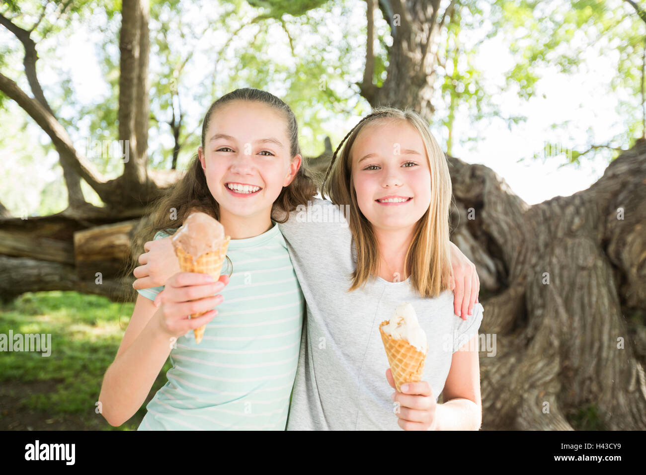 Caucasian girls eating ice cream cones Stock Photo