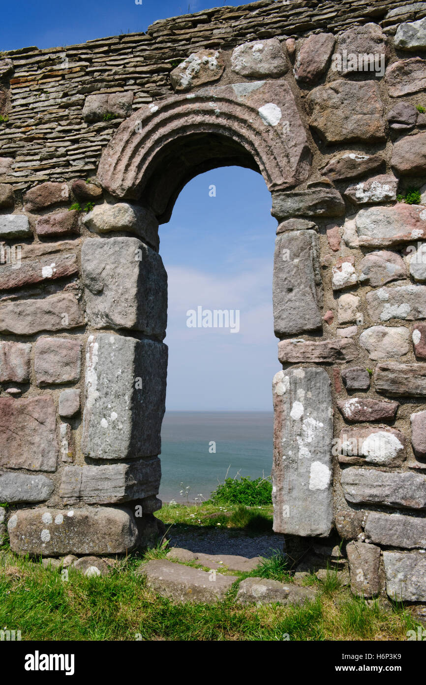 St Patrick's Chapel, Heysham, overlooking Morecambe Bay, Lancashire: S doorway, C8th Anglo-Saxon with upright jamb stones, curved & carved lintel. Stock Photo