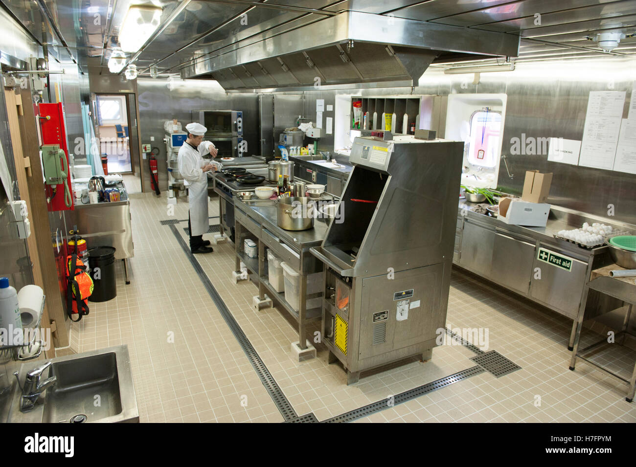 Chef cooking in galley on board a merchant ship Stock Photo