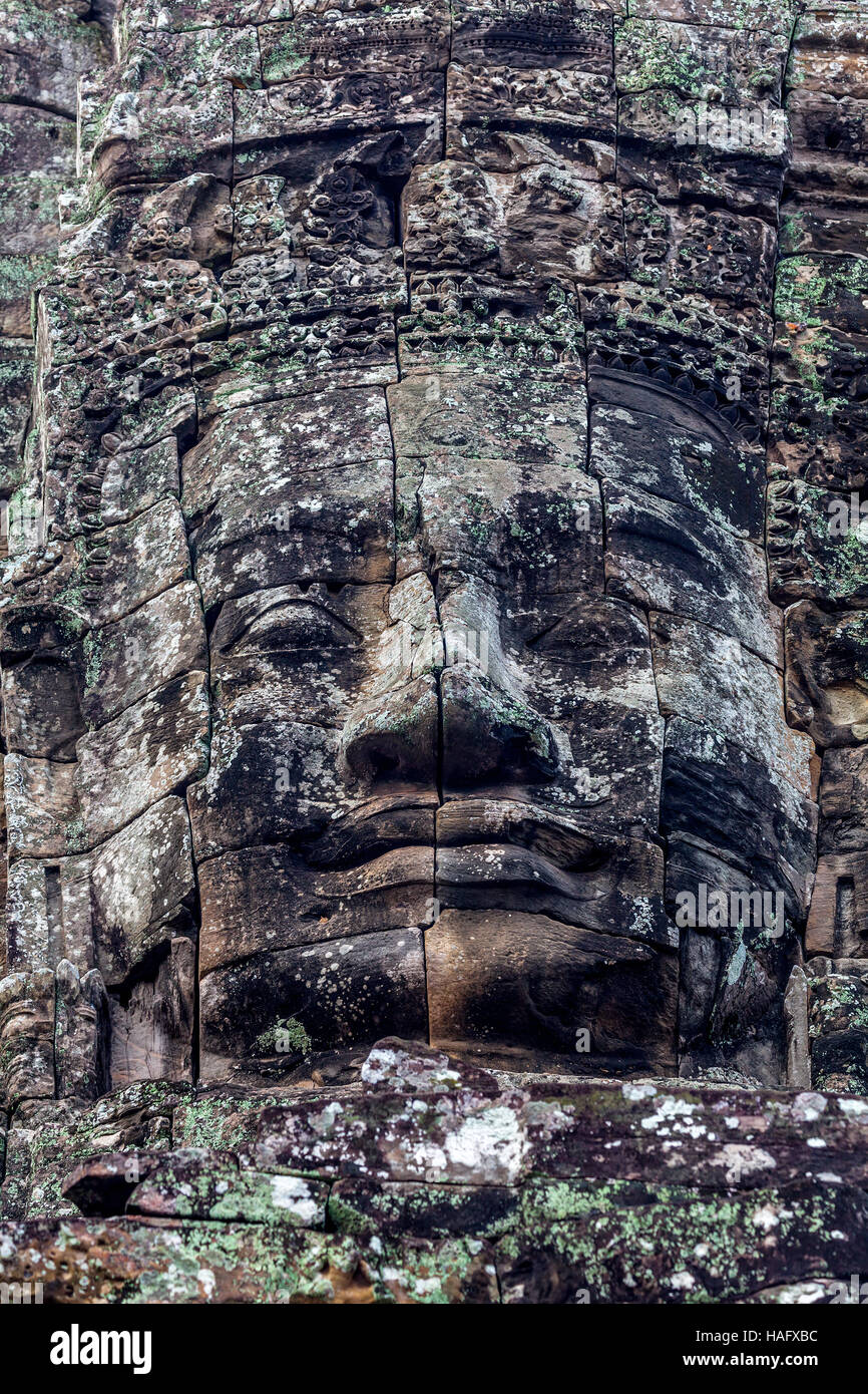 Enigmatic stone face of King Jayavarman VII is at the Bayon, Angkor Thom, Siem Reap, Kingdom of Cambodia. Stock Photo