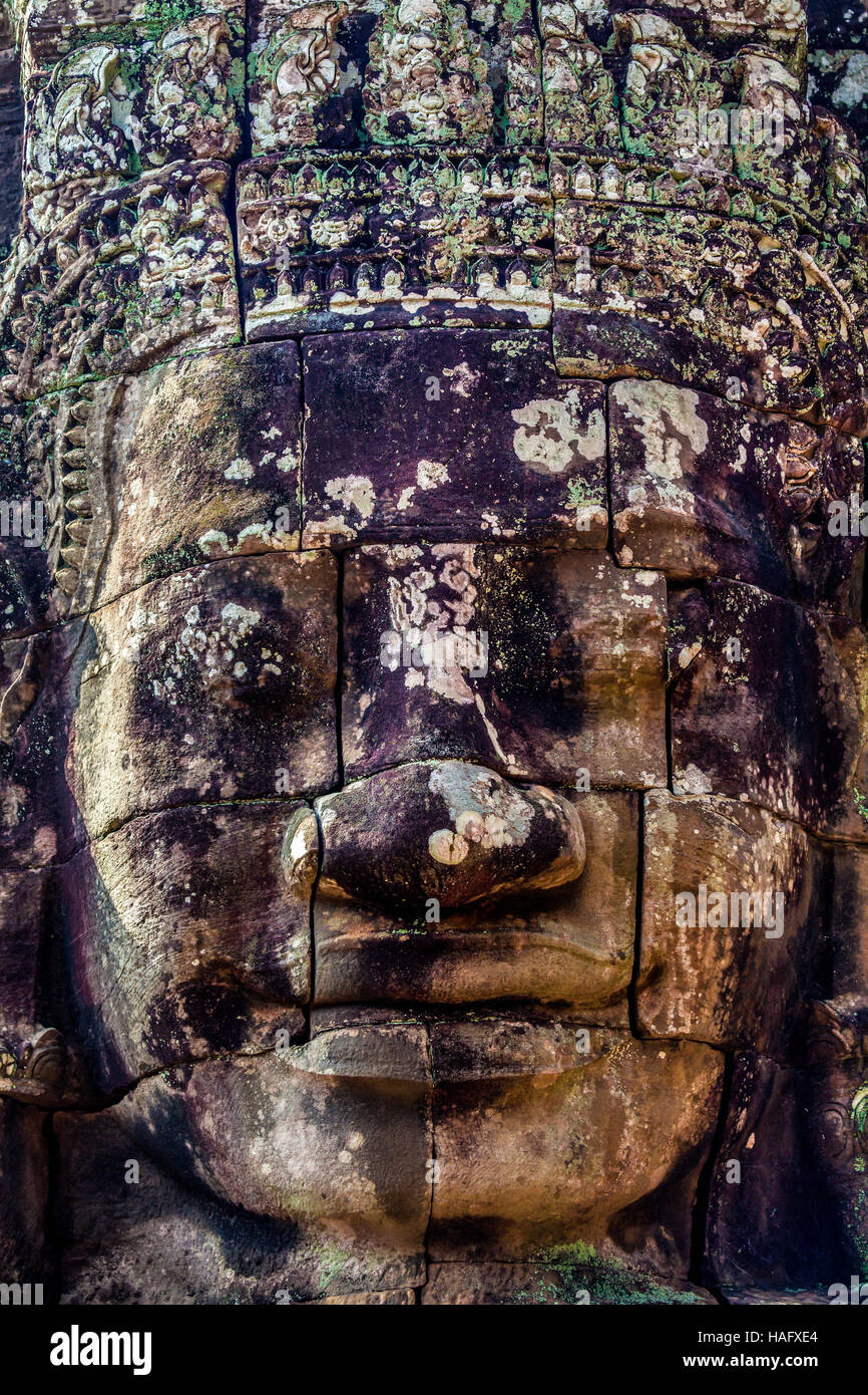 Enigmatic stone face of King Jayavarman VII is at the Bayon, Angkor Thom, Siem Reap, Kingdom of Cambodia. Stock Photo