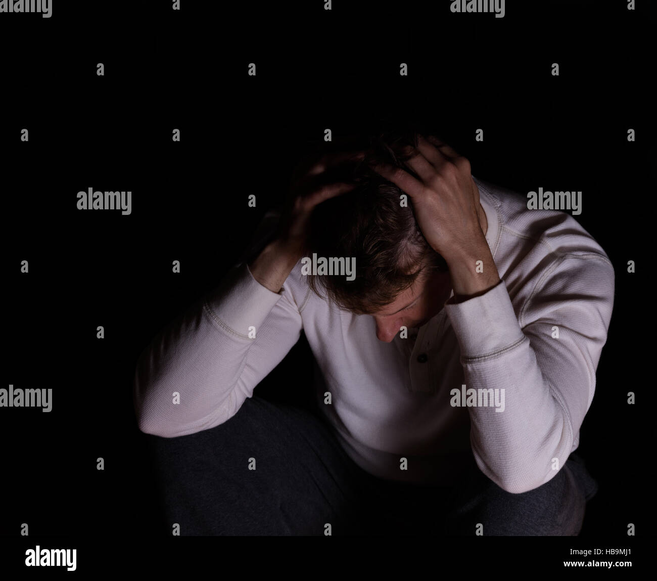 Man showing depression in dark background Stock Photo