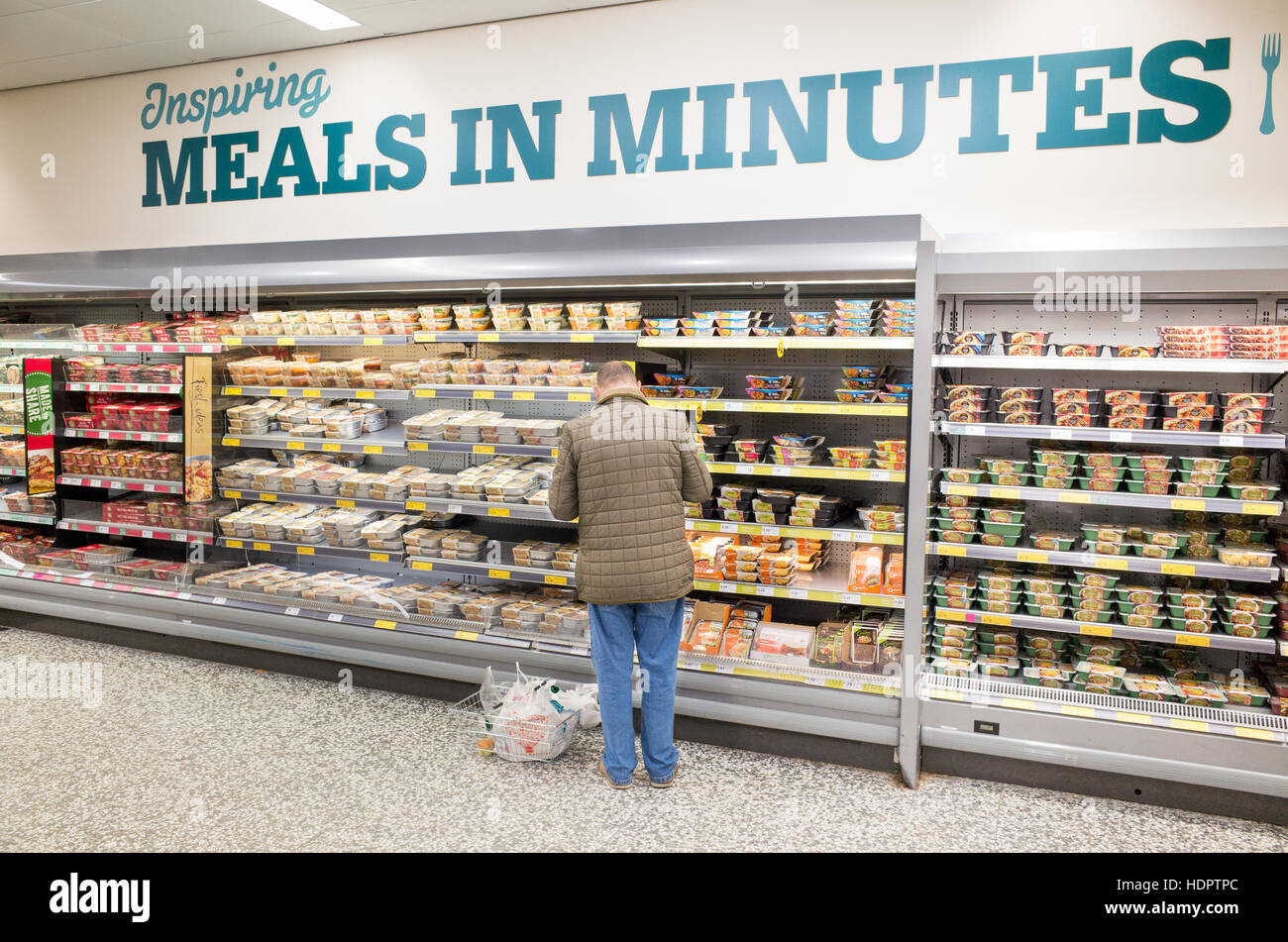 Elderly man shopping for ready meals at Morrisons supermarket, London, England, UK Stock Photo