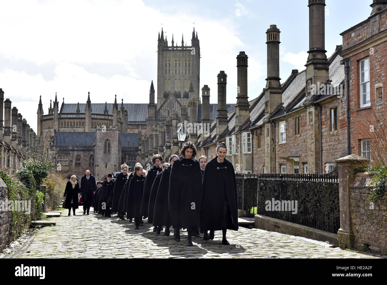 Choristers from Wells Cathedral Choir walking along Vicars Close in cloaks to evensong at the Cathedral on Easter Day. Stock Photo